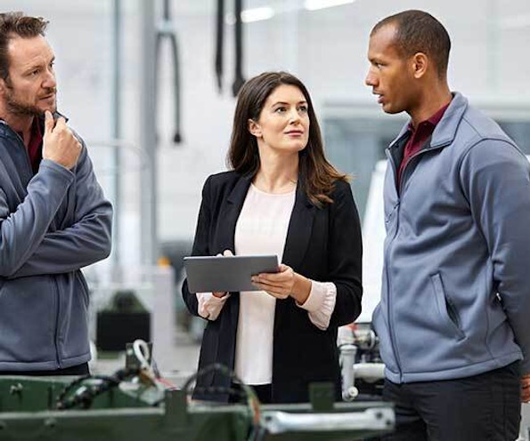 Manufacturing problem solving 830 3 people talking in factory